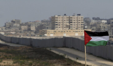 A Palestinian flag is seen with the background of a section of the wall in the Philadelphi corridor between Egypt and Gaza