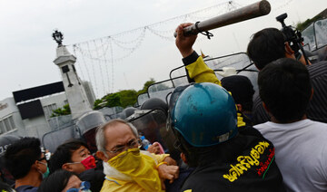 Thai anti-government protesters scuffle with a police during a protest in Bangkok on Saturday. (AFP)