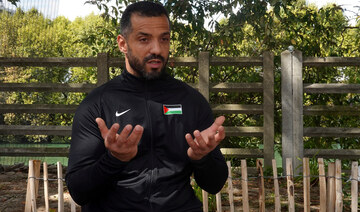 Palestinian Paralympic athlete Fadi Aldeeb talks during an interview outside the Paralympic village in Saint-Denis, France.