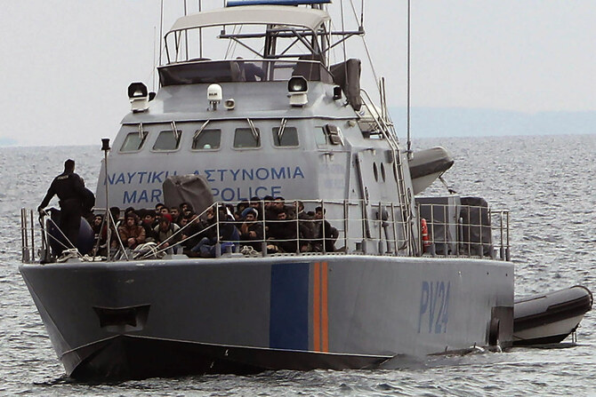 Migrants aboard a Cyprus marine police patrol boat are brought to a harbor after being rescued from their own vessel.