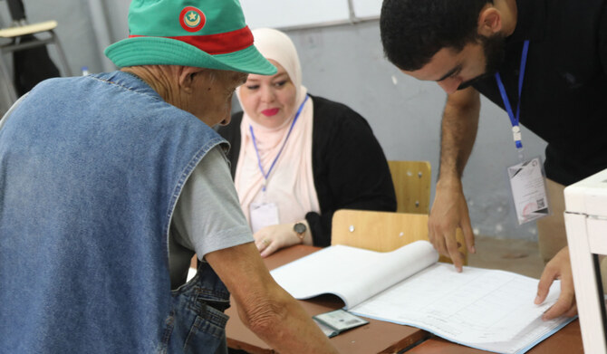 An Algerian man votes at a polling station during the presidential election, in Algiers on September 7, 2024. (AFP)